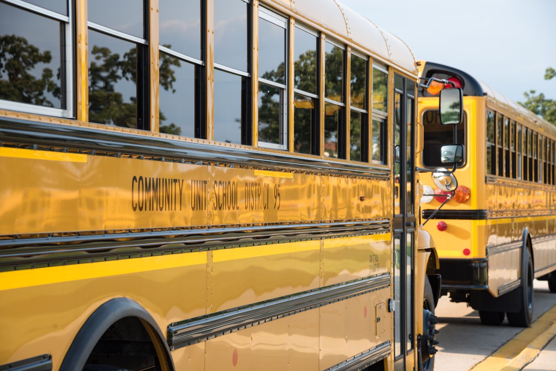 yellow school buses parked in front of school